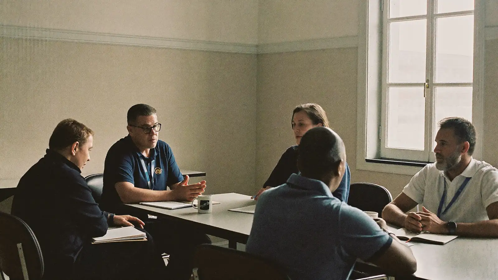 A support professional reviewing a schedule with a colleague in a bright office.