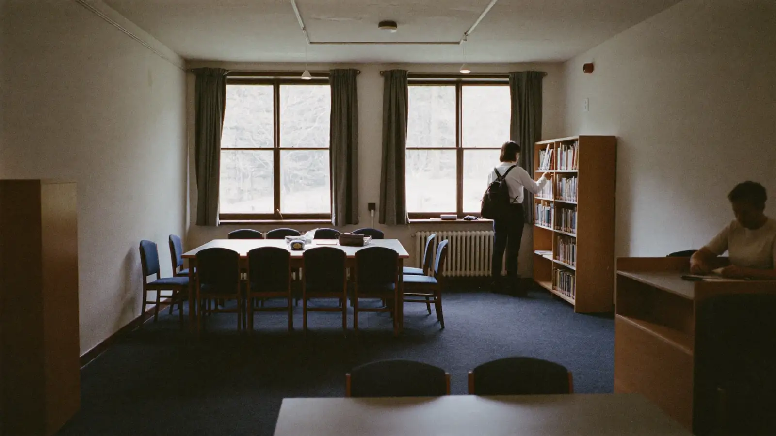 A community resource center with a person reviewing a printed directory at a front desk.
